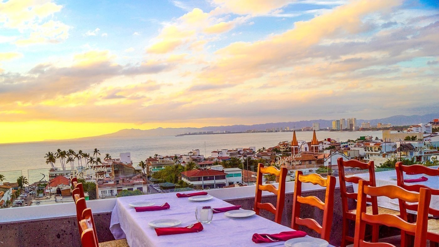 Rooftop table with a view of Puerto Vallarta at sunset